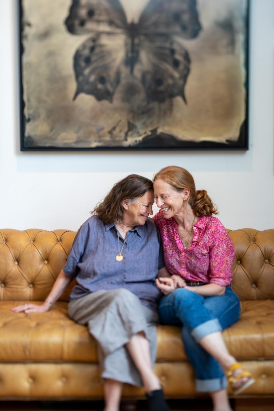 Marianne Wiggins and daughter Lara Porzak touch foreheads.