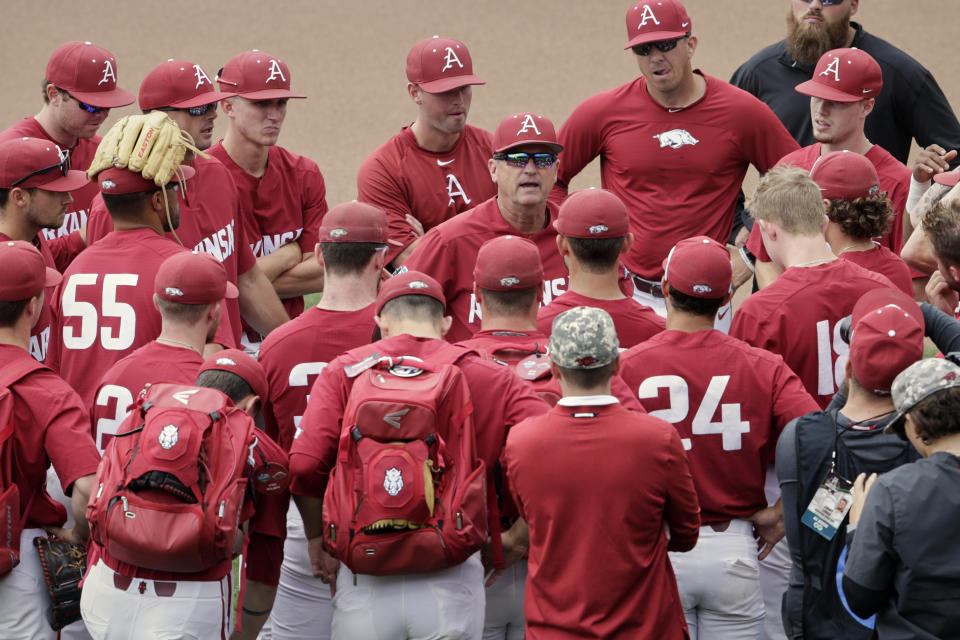 Arkansas NCAA college baseball coach Dave Van Horn, center, addresses his players following practice at TD Ameritrade Park in Omaha, Neb., Friday, June 14, 2019. Arkansas opens College World Series play Saturday night against Florida State, which will be trying to win retiring coach and NCAA all-time wins leader Mike Martin's first national championship in his 17 visits to Omaha. (AP Photo/Nati Harnik)