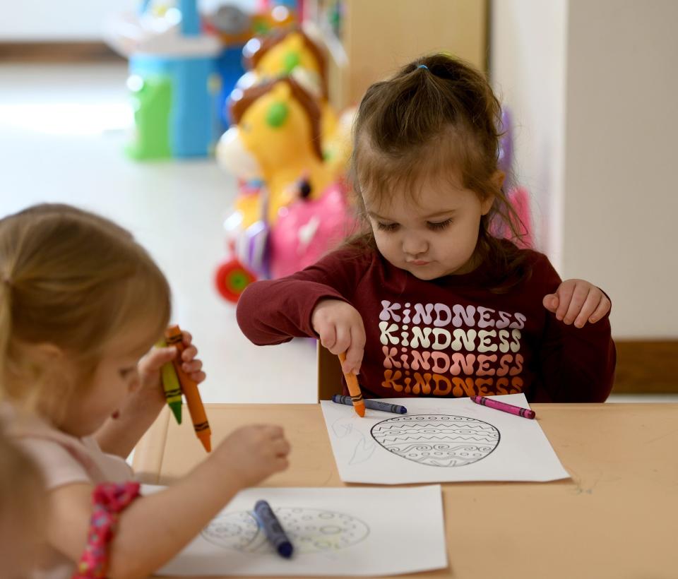 Two-year-old Isabella Heston (right) works on a project Tuesday in the Young Toddlers room at Little Sprouts Daycare & Preschool in Massillon.