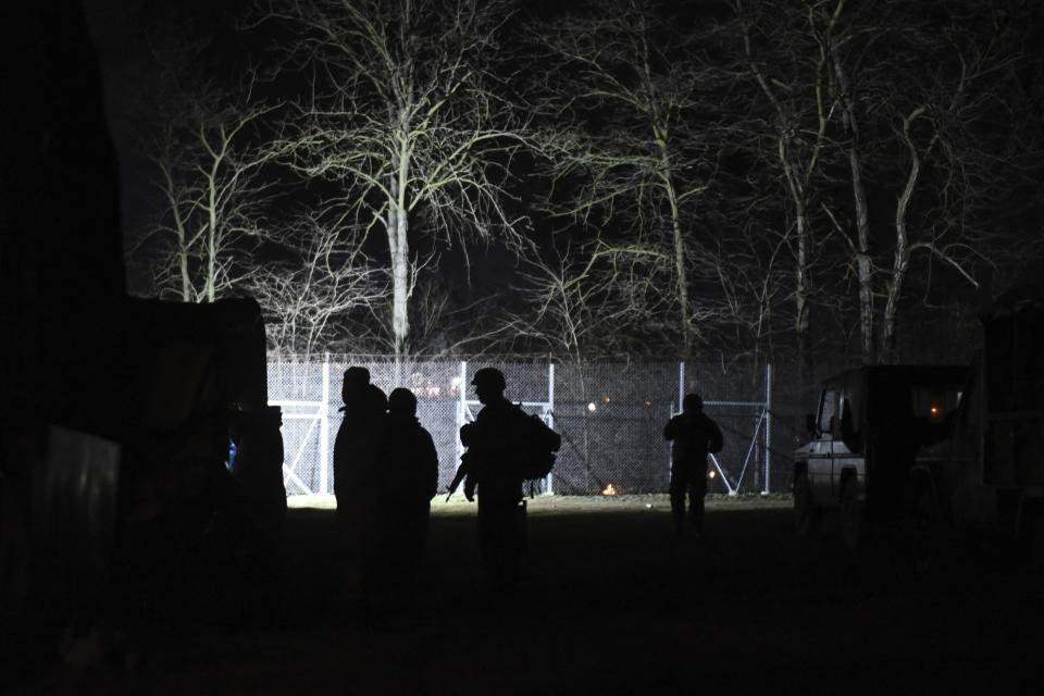 Greek soldiers guard at Kastanies border gate at the Greek-Turkish border, Saturday, Feb. 29, 2020. Turkey's President Recep Tayyip Erdogan said his country's borders with Europe were open Saturday, making good on a longstanding threat to let refugees into the continent as thousands of migrants gathered at the frontier with Greece. (AP Photo/Giannis Papanikos)