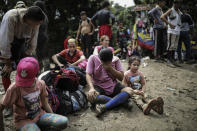 Venezuelan migrants take a break during their walk across the Darien Gap from Colombia to Panama, in hopes of reaching the U.S., Tuesday, May 9, 2023. Pandemic-related U.S. asylum restrictions, known as Title 42, are to expire Thursday, May 11. (AP Photo/Ivan Valencia)