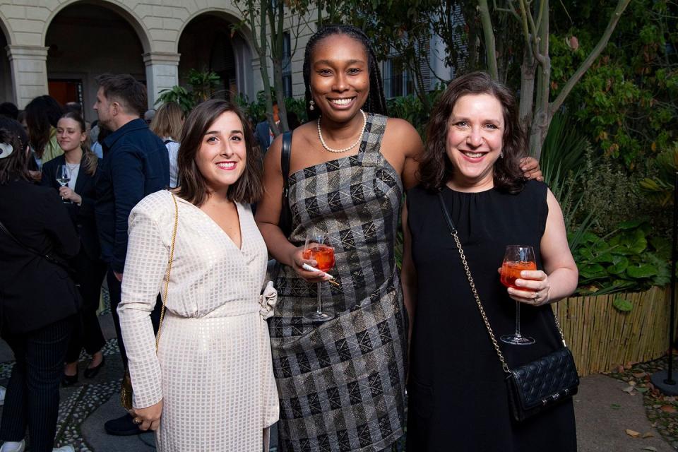 a group of women holding drinks