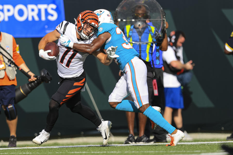 Cincinnati Bengals wide receiver Trent Taylor (11) is tackled by Miami Dolphins cornerback Jamal Perry (33) in the second half of an NFL exhibition football game in Cincinnati, Sunday, Aug. 29, 2021. (AP Photo/Aaron Doster)