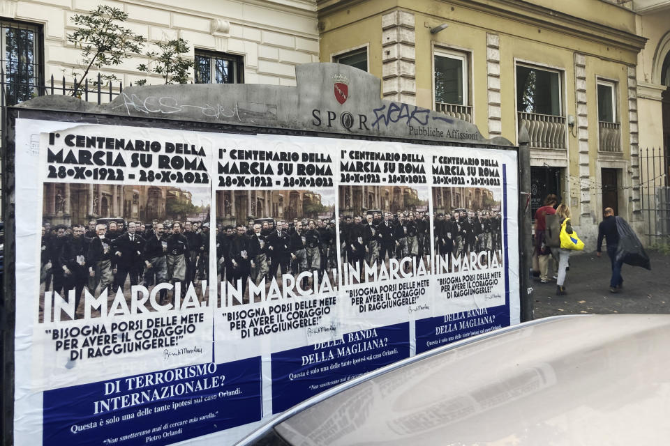 Posters commemorating the 100th anniversary of the March on Rome bearing a picture of Italian Fascist Dictator Benito Mussolini reading: "Marching!" with a quote by Mussolini "you have to set yourself goals to have the courage to reach them" are posted on the Rome's public billboard space, Thursday, Oct. 27, 2022. (AP Photo/Gregorio Borgia)