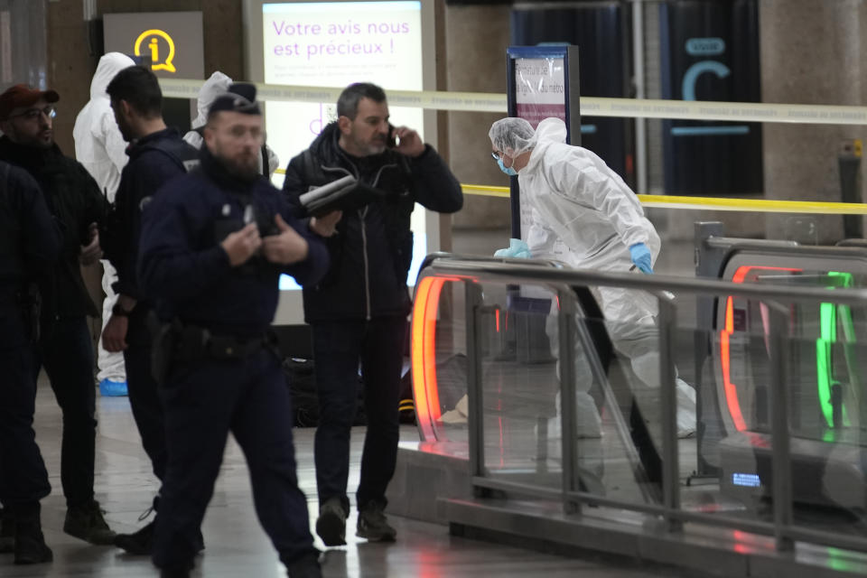 Police investigators work inside the Gare de Lyon station after an attack, Saturday, Feb. 3, 2024 in Paris. A man seemingly armed with a knife and a hammer injured three people Saturday in an early-morning attack at the major Gare de Lyon train station in Paris, another nerve-rattling security incident in the Olympic host city before the Summer Games open in six months. (AP Photo/Christophe Ena)