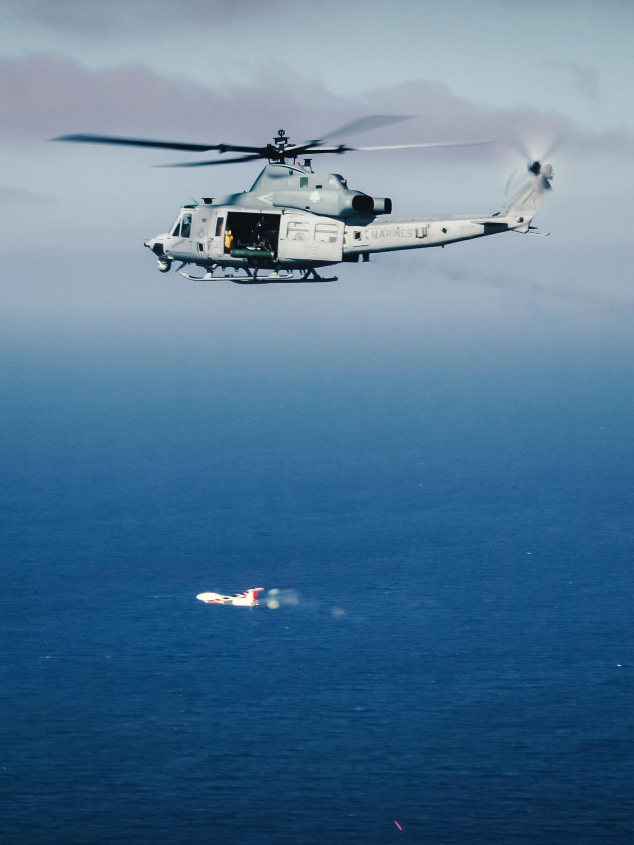 In this Feb. 25, 2019 photo, U.S. Marines with Marine Medium Tiltrotor Squadron 163 (Reinforced), 11th Marine Expeditionary Unit (MEU), engage an unmanned aerial system with a GAU-17 minigun during a drone interception live-fire exercise in the Pacific Ocean.