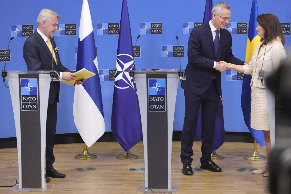 Finland's Foreign Minister Pekka Haavisto, left, Sweden's Foreign Minister Ann Linde, right, and NATO Secretary General Jens Stoltenberg attend a media conference after the signature of the NATO Accession Protocols for Finland and Sweden in the NATO headquarters in Brussels, Tuesday, July 5, 2022. (AP Photo/Olivier Matthys)