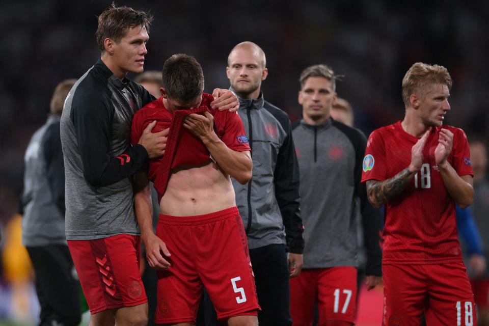 Pictured here, Denmark players react with disappointment to their Euro 2020 semi-final defeat.