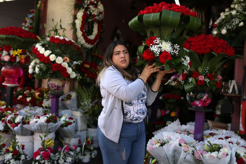 A woman sells flowers in the flower district ahead of Valentine's Day in Los Angeles