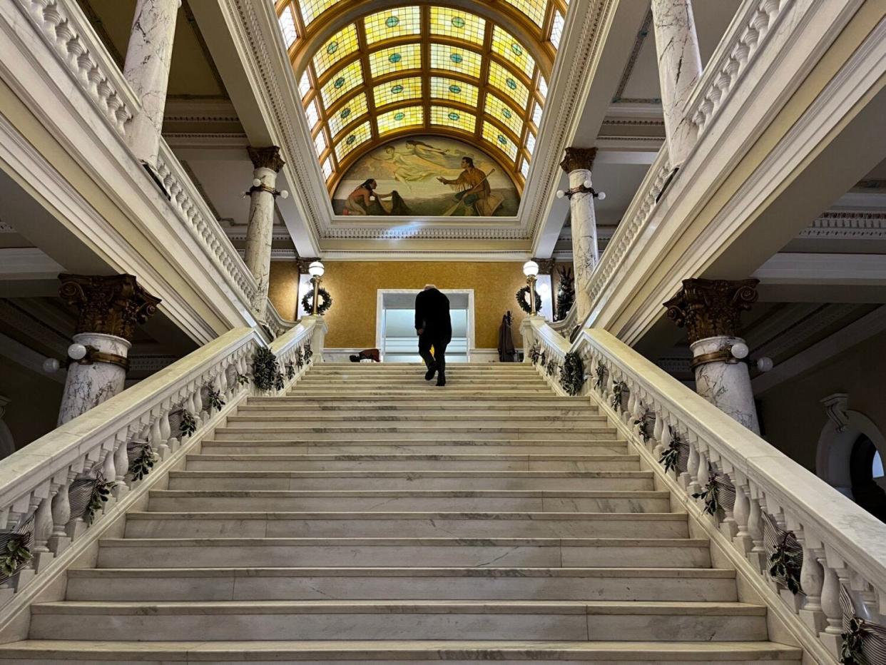 A person climbs the stairs of the South Dakota Capitol.