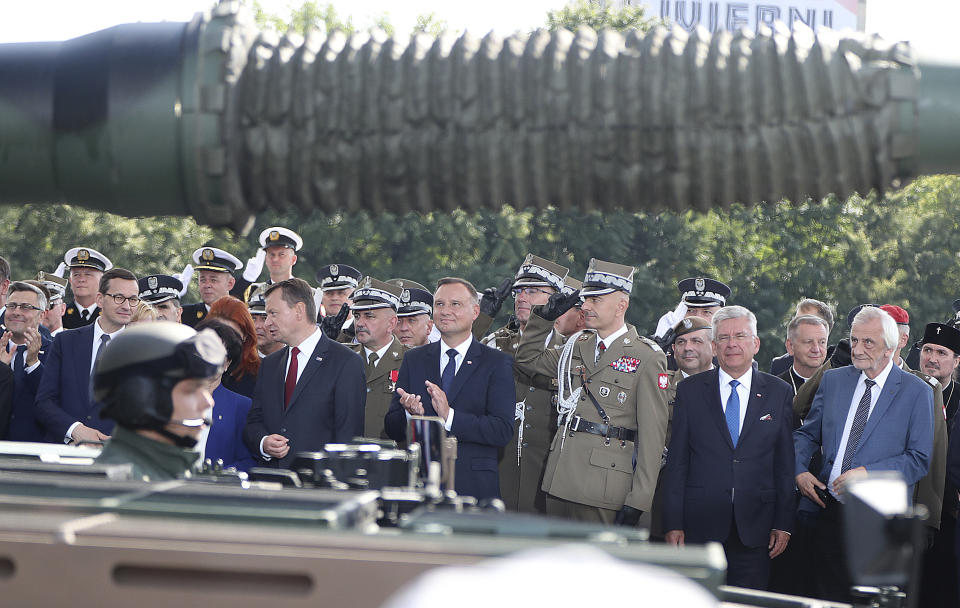 Poland's president Andrzej Duda, center, during the annual Armed Forces review during a national holiday, in Katowice, Poland, Thursday, Aug. 15, 2019. Large crowds turned out for the celebration which this year included a fly-over by two U.S. F-15 fighter jets. (AP Photo/Czarek Sokolowski)