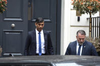 Outgoing British Prime Minister Rishi Sunak, left, leaves the Conservative Campaign Headquarters in London, Friday, July 5, 2024. Britain's Labour Party swept to power Friday after more than a decade in opposition, as a jaded electorate handed the party a landslide victory, but also a mammoth task of reinvigorating a stagnant economy and dispirited nation. (AP Photo/Thomas Krych)