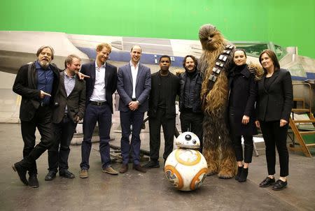 (L-R) US actor Mark Hamill, US director Rian Johnson, Britain's Prince Harry, Britain's Prince William, Duke of Cambridge, British actor John Boyega, Chewbacca and British actress Daisy Ridley pose during a tour of the Star Wars sets at Pinewood studios in Iver Heath, west of London, Britain on April 19, 2016. REUTERS/Adrian Dennis/Pool