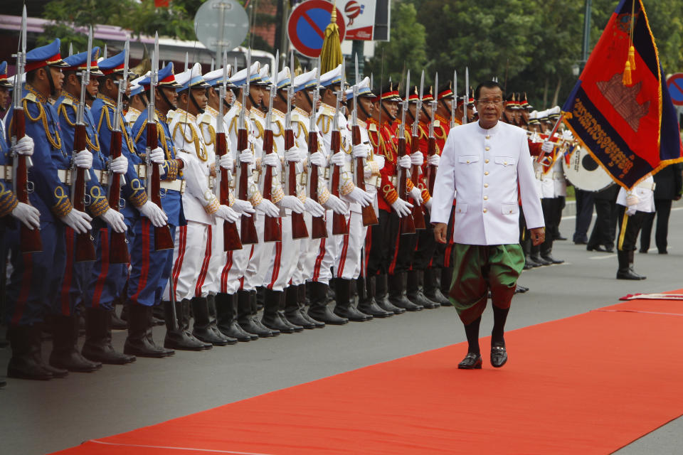 Cambodia's Prime Minister Hun Sen, right, reviews honorary troop in front of the National Assembly in Phnom Penh, Cambodia, Wednesday, Sept. 5, 2018. Cambodia National Assembly on Wednesday opening its the first session presided over by King Norodom Sihamoni to ensure long-ruling Prime Minister Hun Sen another term after his party swept election in late July. (AP Photo/Heng Sinith)