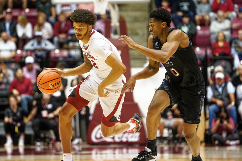 Alabama forward Darius Miles (2) dribbles past Memphis guard Elijah McCadden (0) during a Dec. 13, 2022 game.