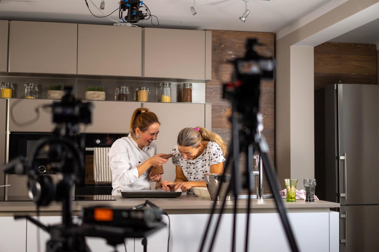 Woman making a movie in a kitchen