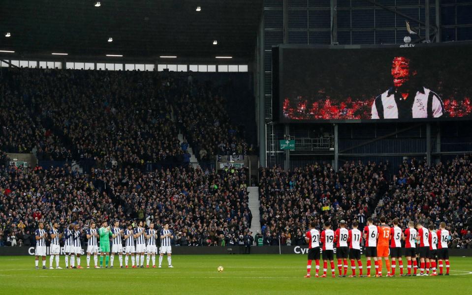 Players line up during a minute's applause in remembrance of Cyrille Regis - Action Images via Reuters