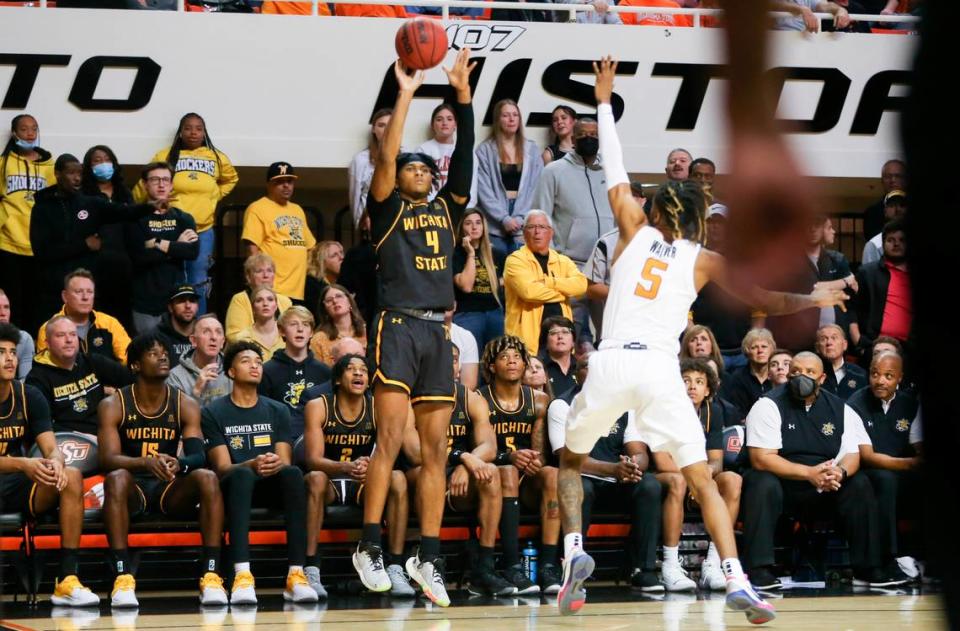 Wichita State’s Ricky Council IV hits a three pointer over Oklahoma State’s Rondel Walker in the second half on Wednesday in Stillwater.