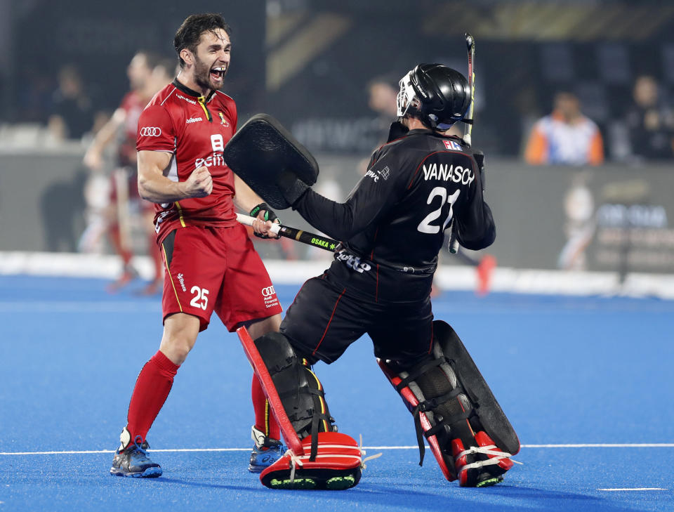 Belgium's Loick Luypaert, left, celebrates with teammate Vincent Vanasch after their win in the Men's Hockey World Cup quarterfinal match between Belgium and Germany at the Kalinga Stadium in Bhubaneswar, India, Thursday, Dec. 13, 2018. Belgium won the match 2-1. (AP Photo/Aijaz Rahi)