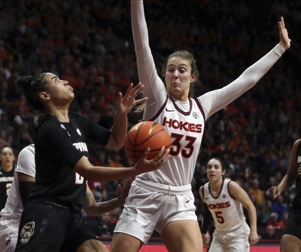 North Carolina State's Madison Hayes, left, drives while defended by Virginia Tech's Elizabeth Kitley (33) during the first half of an NCAA college basketball game Sunday, Feb. 19, 2023, in Blacksburg, Va. (Matt Gentry/The Roanoke Times via AP)