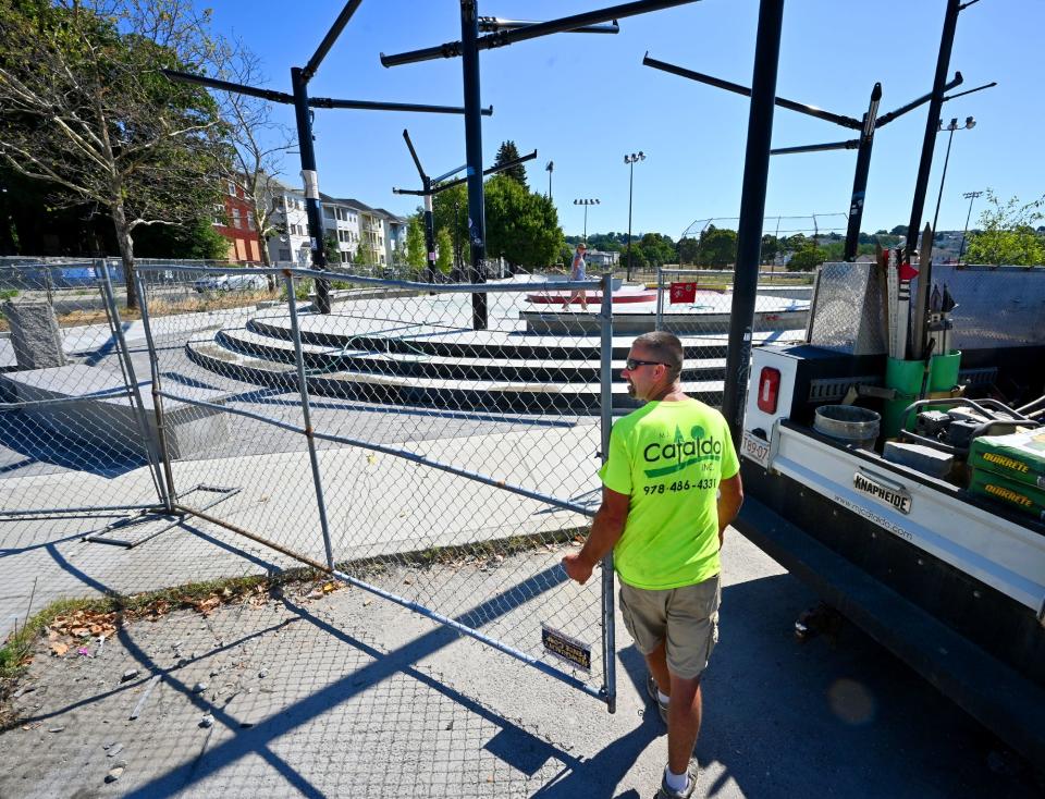 Cataldo, Inc. employee Dan Martin of Westminster closes the gate Friday at the Crompton Park skateboard park in Worcester after doing contractor work on the park, which is set to open next month.
