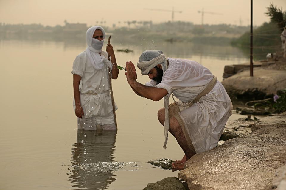 In this Sunday, Oct. 14, 2018 photo, followers of the ancient Mandaean religious sect perform their rituals along a strip of embankment on the Tigris River reserved for them, in Baghdad, Iraq. Mandaeanism follows the teachings of John the Baptist, a saint in both the Christian and Islamic traditions, and their rituals revolve around water. Iraq’s soaring water pollution is threatening the religious rites of the tight-knit community, already devastated by 15 years of war. (AP Photo/Hadi Mizban)