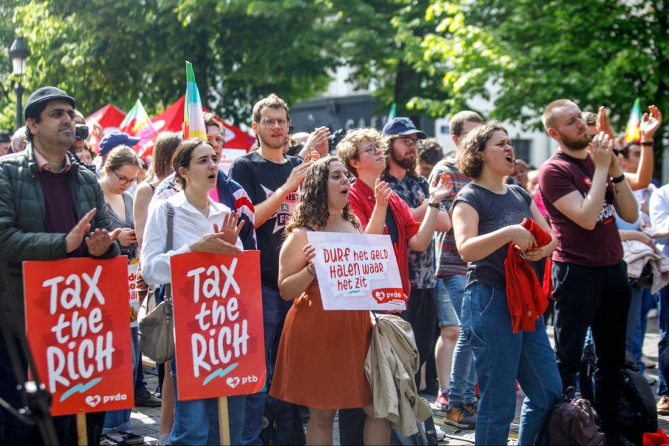 Demonstrators with ‘Tax the rich!’ placards in Brussels, Belgium, on International Workers’ Day 2024 (Hatim Kaghat/AFP/Getty)