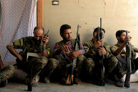 FILE PHOTO:Members of the Syrian Democratic Forces keep guard at their advanced position, during the fighting with Islamic State's fighters in Nazlat Shahada, a district of Raqqa, Syria August 16, 2017. REUTERS/Zohra Bensemra/File Photo