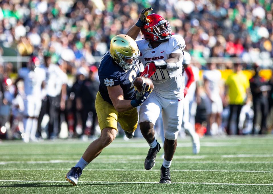 Notre Dame tight end Michael Mayer (87) makes a catch as UNLV linebacker Fred Thompkins (10) defends him during the Notre Dame vs. University of Nevada NCAA football game Saturday, Oct. 22, 2022 at Notre Dame Stadium in South Bend.