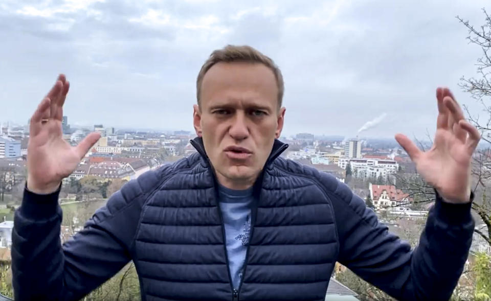 In this handout photo taken from a video released on Wednesday, Jan. 13, 2021, by Russian opposition activist Alexei Navalny in his instagram account, Russian opposition activist Alexei Navalny gestures as he records his address. Top Kremlin critic Alexei Navalny says he will fly home to Russia over the weekend despite the Russian prison service's latest motion to put him behind bars for allegedly breaching the terms of his suspended sentence and probation. (Navalny instagram account via AP)