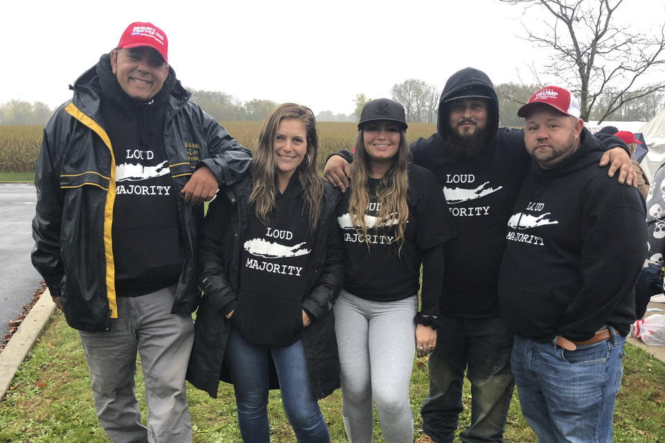 Matt Vereline, left, and other members of "Long Island Loud Majority" at a pre-election Trump rally in Lititz, Pa., on Oct. 26, 2020. Vereline, a member of the pro-Trump group “Long Island Loud Majority” is not in the mood of reconciliation. Vereline, who live Bohemia, N.Y., is convinced “there was a lot more voter fraud than we know about,” though he's not sure whether it changed the outcome. But that won't keep him from rallying around what he thinks was an injustice. After all, that's what Democrats did to Trump, he says. (AP Photo/Jill Colvin)