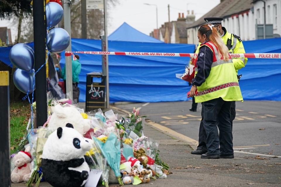 People lay flowers near the scene in Sutton, south London (Yui Mok/PA) (PA Wire)