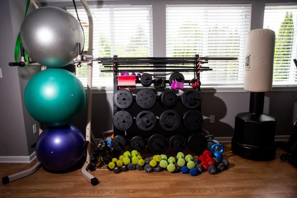 Exercise equipment sits lined up in the studio of health and wellness coach Amanda Villarreal Wednesday, May 24, 2023, in Zeeland.