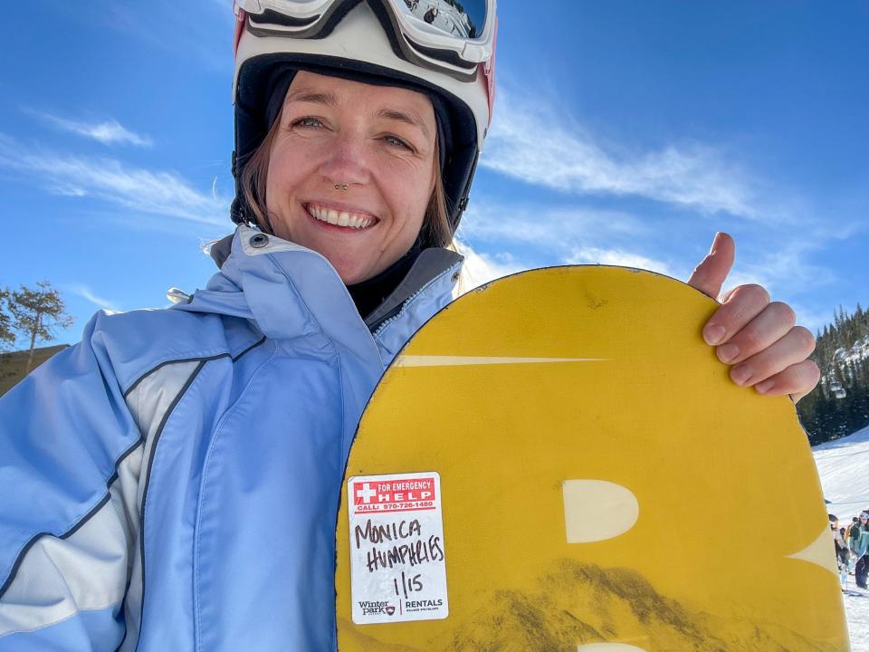 The author holds a snowboard.