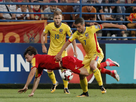 Soccer Football - 2018 World Cup Qualifications - Europe - Montenegro vs Romania - Podgorica, Montenegro - September 4, 2017 Romania's Alexandru Chipciu in action with Montenegro's Filip Stojkovic. REUTERS/Stevo Vasiljevic