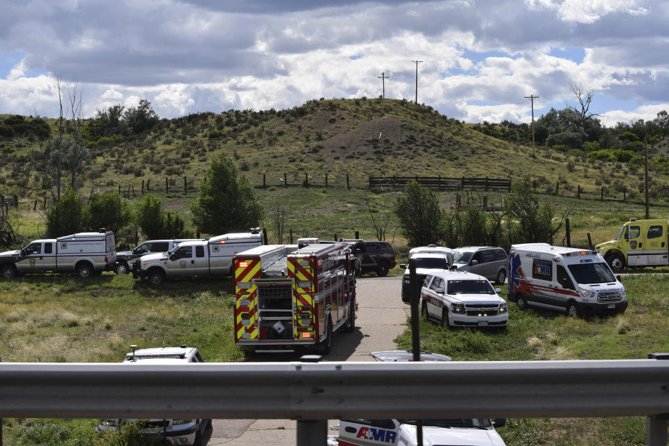 Emergency crews respond to a bus crash on southbound Interstate 25 in Pueblo County, Colo., Sunday afternoon, June 23, 2019. A charter bus carrying more than a dozen people ran off the highway after striking a bridge support Sunday in southern Colorado, killing a few people and injuring several others, a state patrol official said. (Zach Hillstrom/The Pueblo Chieftain via AP)