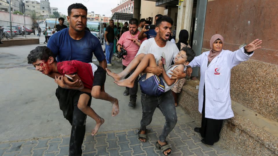 Palestinians carry children wounded by an Israeli strike, at Nasser hospital, on July 22. People displaced in Khan Younis expressed anger at Israel, Hamas and other Arab leaders for the war. - Hatem Khaled/Reuters