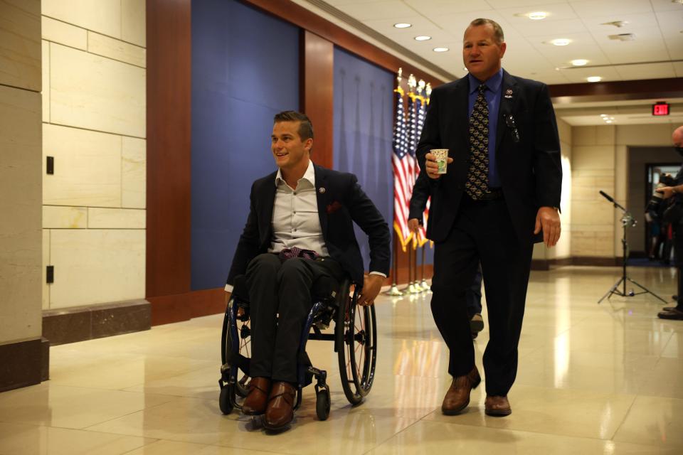 Rep. Madison Cawthorn, R-N.C., left, and Rep. Troy Nehls, R-Texas, arrive May 14, 2021, at a caucus meeting to pick a replacement for Rep. Liz Cheney, R-Wyo., as chair of the House Republican Conference in the U.S. Capitol Visitors Center in Washington, D.C.