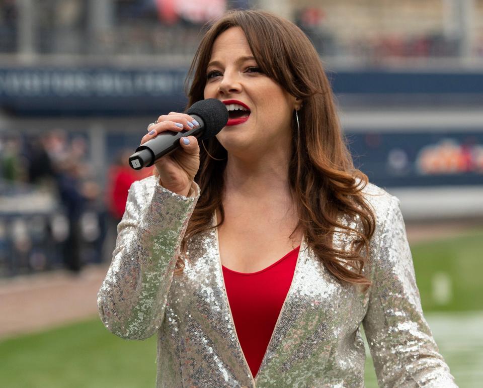 Worcester singer Cara Brindisi, who competed on "The Voice" television show, sings the national anthem Friday at Polar Park.
