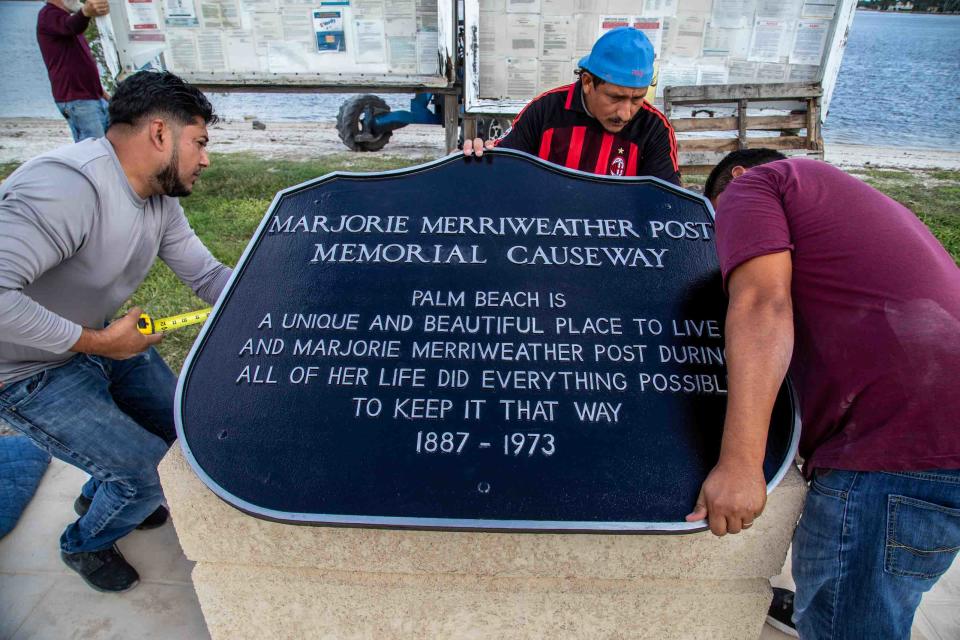 Contractors work Thursday to reinstall the Marjorie Post Causeway Memorial just west of Mar-a-Lago on Southern Boulevard. Herpel Cast Stones & Column, which installed the memorial in 1975, was in charge of the restoration project.