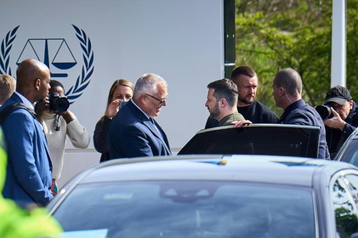 Ukrainian President Volodymyr Zelensky (C-R) arrives at the International Criminal Court in The Hague in May 2023