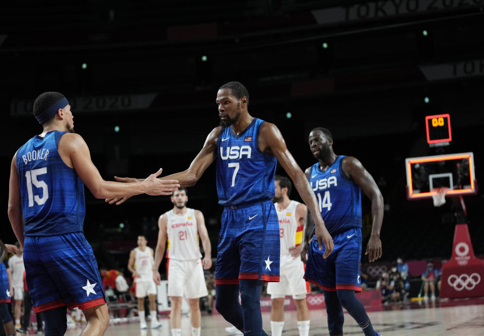 United States' Kevin Durant (7), center, and teammates celebrate their win in the men's basketball quarterfinal game against Spain at the 2020 Summer Olympics, Tuesday, Aug. 3, 2021, in Saitama, Japan. (AP Photo/Eric Gay)