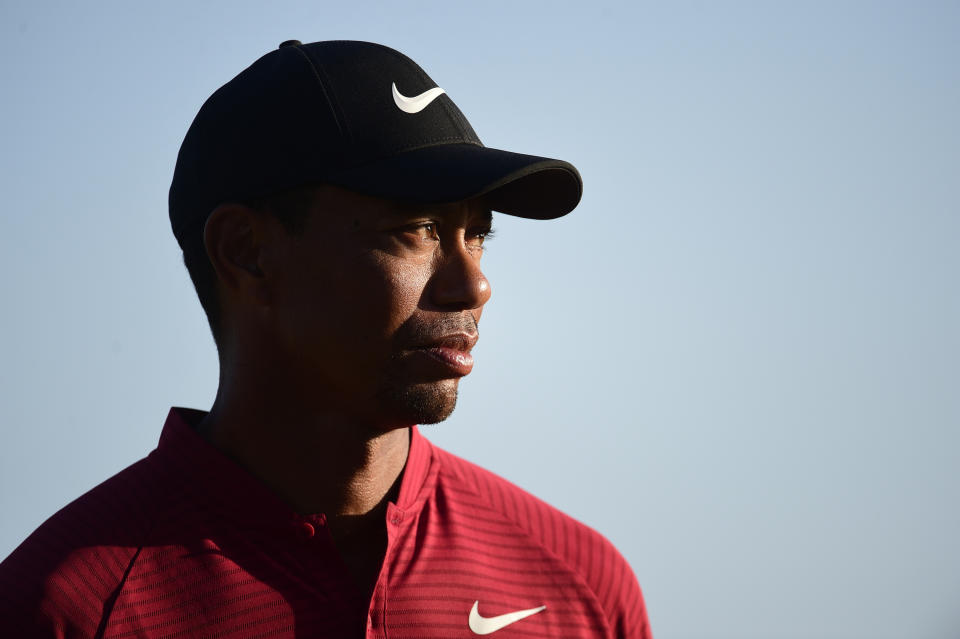 U.S. golfer Tiger Woods stands near the Hero World Challenge trophy before presenting it to Spain's Jon Rahm at Albany Golf Club in Nassau, Bahamas, Sunday, Dec. 2, 2018. (AP Photo/Dante Carrer)