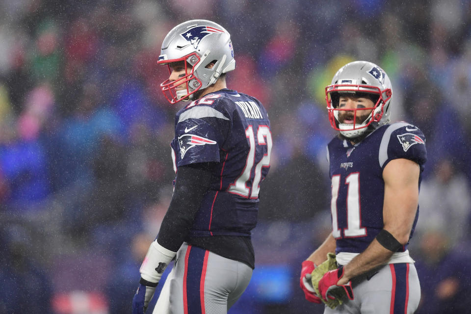 Tom Brady and Julian Edelman on the field together in Patriots uniforms.