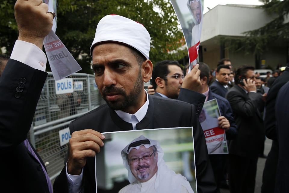 A member of the Turkish-Arab journalist association hold a poster with the photo of missing Saudi writer Jamal Khashoggi, during a protest near the Saudi Arabia consulate in Istanbul, Monday, Oct. 8, 2018. Khashoggi, 59, went missing on Oct 2 while on a visit to the consulate in Istanbul for paperwork to marry his Turkish fiancée. The consulate insists the writer left its premises, contradicting Turkish officials. He had been living since last year in the U.S. in a self-imposed exile, in part due to the rise of Prince Mohammed, the son of King Salman. (AP Photo/Lefteris Pitarakis)