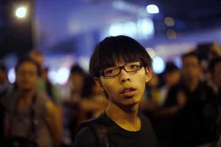 Joshua Wong, leader of the student movement, pauses as he talks to reporters outside the government headquarters office in Hong Kong in this October 9, 2014 file photo. REUTERS/Carlos Barria/Files