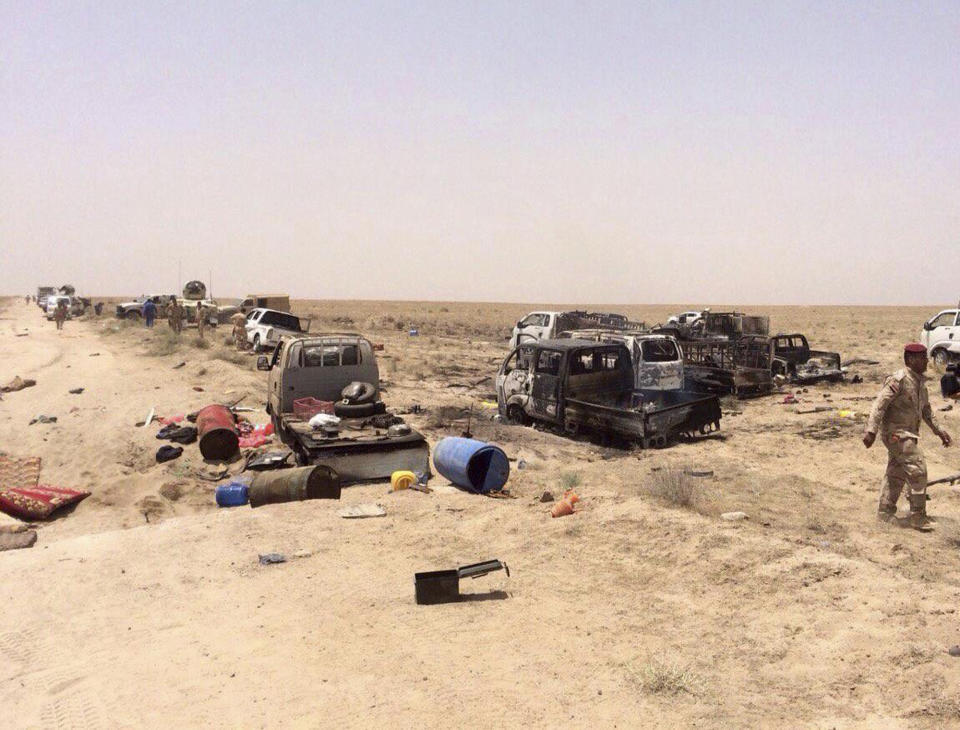 FILE - In this June 29, 2016, file photo, Iraqi security forces inspect vehicles belonging to escaping Islamic State militants outside Fallujah, Iraq. (AP Photo, file)