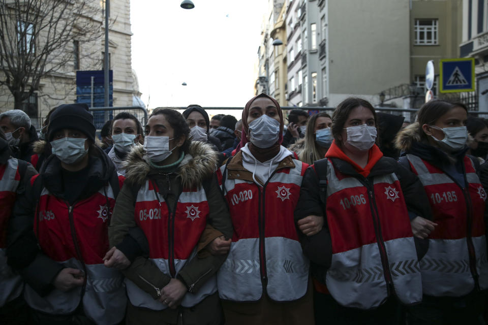 Female police officers block the way to protesters during an attempted march to mark International Women's Day in Istanbul, Monday, March 8, 2021.Thousands of people joined the march to denounce violence against women in Turkey, where more than 400 women were killed last year. The demonstrators are demanding strong measures to stop attacks on women by former partners or family members as well as government commitment to a European treaty on combatting violence against women. (AP Photo/Emrah Gurel)