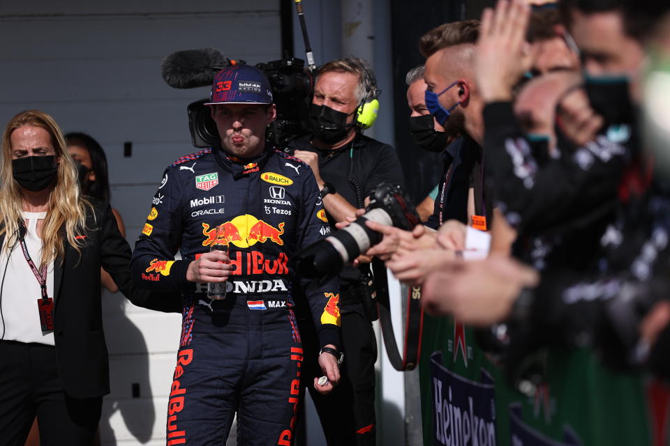 Red Bull driver Max Verstappen, of The Netherlands, has a drink after coming in second in the Brazilian Formula One Grand Prix in Sao Paulo, Brazil, Sunday, Nov. 14, 2021. (Lars Baron, Pool Photo via AP)