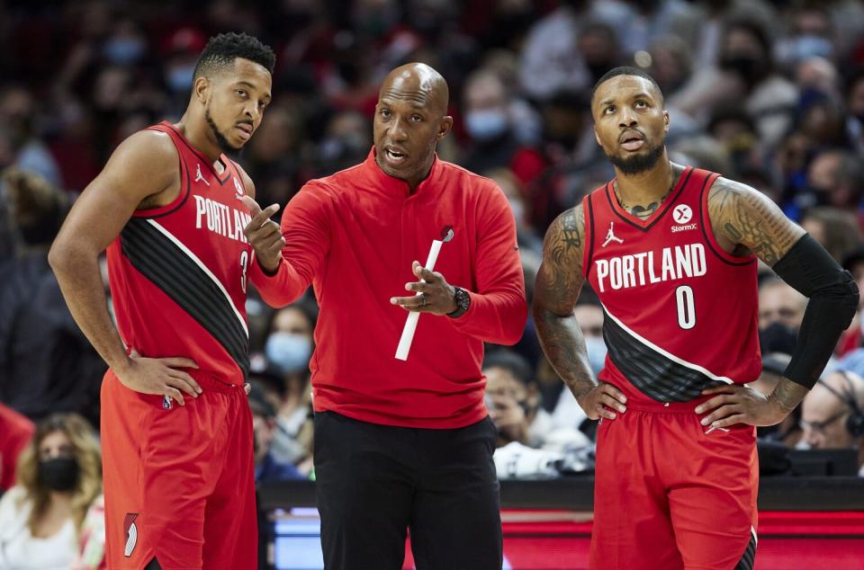 Portland Trail Blazers coach Chauncey Billups talks to guards CJ McCollum and Damian Lillard.